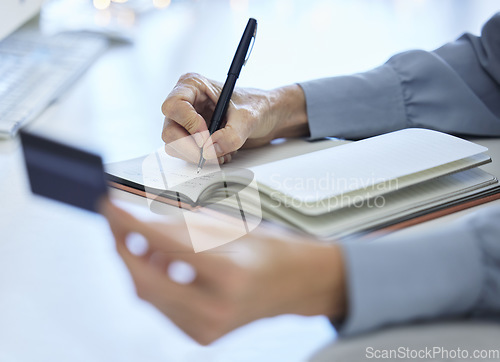 Image of Hand, writing and credit card with woman planning financial budget in notebook for investment and savings. Finance, accounting and debit card for budgeting on paper or document for accounting