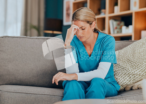 Image of Worry, stress and burnout woman nurse sitting on sofa of modern apartment home sad with depression from work. Hand on head, anxiety and tired nursing in mental health distress on couch of living room