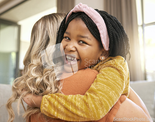 Image of Hug, mother and adopted black girl in living room of house, foster home or orphanage in support, trust and security. Portrait, smile or foster mom with happy child, kid or youth in thank you embrace