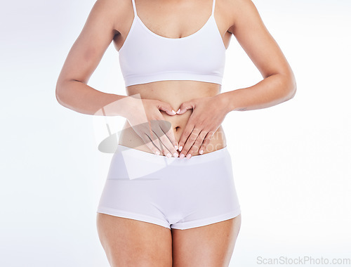 Image of Health, heart and hands on woman stomach for training, nutrition and balance gut wellness. Menstruation, digestion and fitness with girl body for diet, probiotics or hair removal in white background