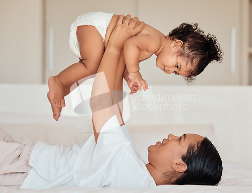 Image of Love, mother and baby in the air in bedroom, being playful and bonding together in home. Mama, toddler and child playing on bed, being loving and connect for quality time, happiness and have fun.