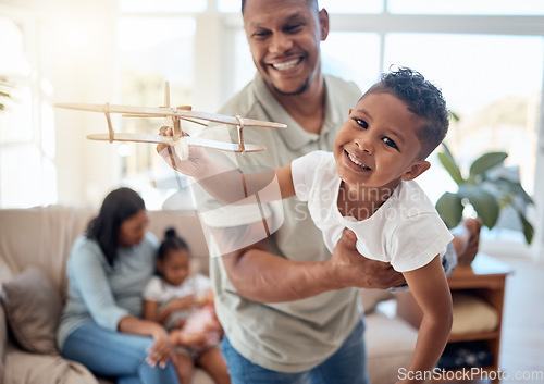 Image of Dad, boy and toy plane in living room for game, fun or bonding while happy together. Father, son and play airplane toys with smile at house with love, happiness or family home lounge in Orlando