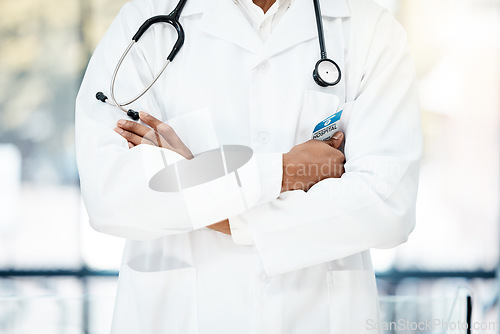 Image of Closeup, healthcare and doctor with arms crossed, stethoscope and confidence in hospital. Medical professional, uniform and consultant healthy, in clinic and medicine for wellness and surgery.