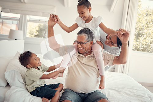 Image of Family, grandfather and piggy back on bed, having fun and bonding. Support, love and care of grandpa, mom and kids playing, enjoying quality time together and relaxing in house on weekend in bedroom.