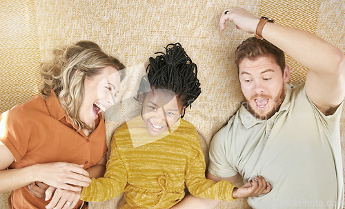 Image of Happy, adoption and interracial family relaxing, playing and bonding together in their home. Happiness, love and multiracial parents with their girl child resting in the living room of a modern house