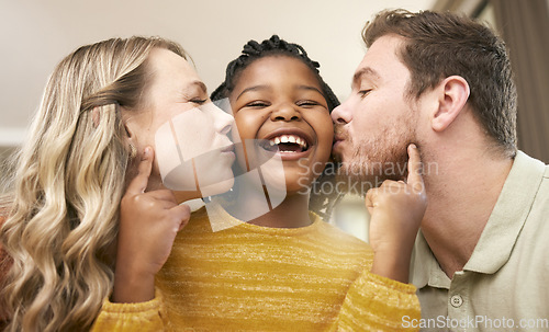 Image of Love, foster and parents kiss daughter for adopted relationship bonding in loving, caring home. Adoption, interracial and mother and father with cheerful little girl being kissed in house