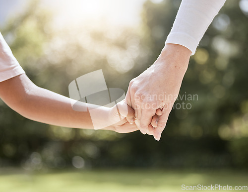 Image of Park, family and parent holding hands with child enjoying nature, summer holiday and weekend together. Bonding, support and person holding hand of young kid with affection, love and care in nature