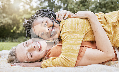 Image of Happy family, mother hug and nature of a interracial girl and mama with love in a picnic park. Portrait of happy, relax and smile of a mother and daughter together on a floor with diversity adoption