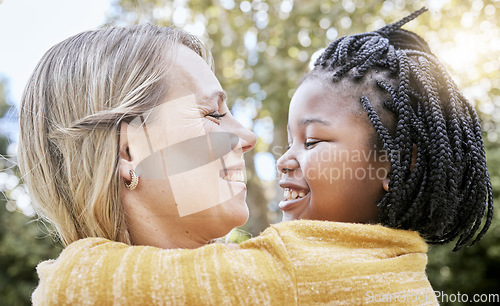 Image of Hug, smile and mother love with girl in a nature park with love, foster care and diversity. Happy, relax and hugging mom and adopted kid bonding together in summer on mothers day or holiday outdoor
