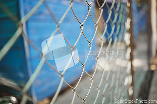 Image of Steel, iron or metal fence for safety with a blurred background at an outdoor shelter or clinic. Chain link, veterinary and closeup of a wire barrier for security outside with enclosure or barricade.