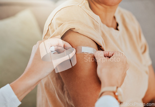 Image of Healthcare, doctor and patient with covid vaccine injection plaster on arm for immune medicine, bandaid and medical treatment to prevent disease. Clinic vaccination, safe and healthy woman after shot