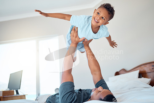 Image of Father lifting kid in air in the bedroom having fun, playing and enjoying morning together. Bonding, love and dad holding young child in bed to pretend to fly for quality time and relax with family