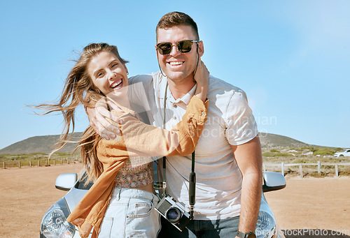 Image of Couple, hug and road trip on a summer desert holiday together with love, smile and adventure. Portrait of a happy couple about to travel by motor transport for vacation with freedom and happiness