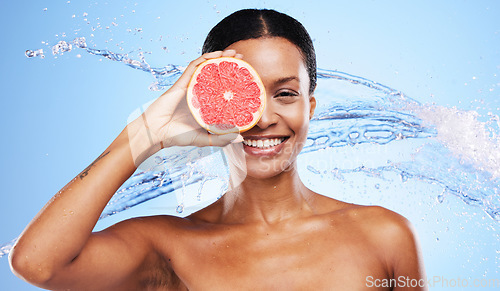 Image of Beauty, skincare and water splash with black woman and grapefruit over eye for vitamin c, luxury and spa. Shower, hydration and moisture with portrait of girl model and citrus fruit for health detox