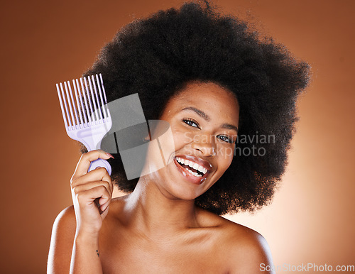 Image of Beauty, hair and afro and black woman and comb for self care, natural and freedom. Happy, smile and untangling with portrait of African girl model and curly hair for luxury and confidence