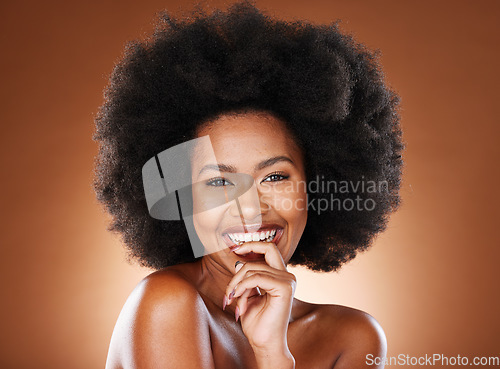 Image of Happy, black woman and hair care with smile, skincare and with afro, glow and beauty in browns studio background. Portrait, cosmetic or skin health of a person with happiness, content or smiling joy