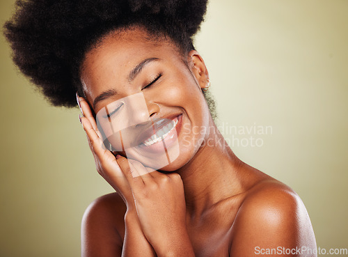 Image of Black woman, hands and smile for facial skincare, makeup or cosmetics against a studio background. African American female smiling in satisfaction for beautiful cosmetic treatment or perfect skin