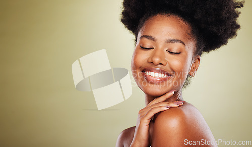 Image of Beauty, skincare and black woman in a studio for a natural face routine with mockup space. Happy, smile and African model with a smile doing a facial treatment by a green background with copy space.