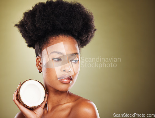 Image of Coconut, beauty and black woman in studio for natural hair care, skincare and healthy product marketing or advertising mockup. African model with coconut oil cream for skin care glow or hair growth