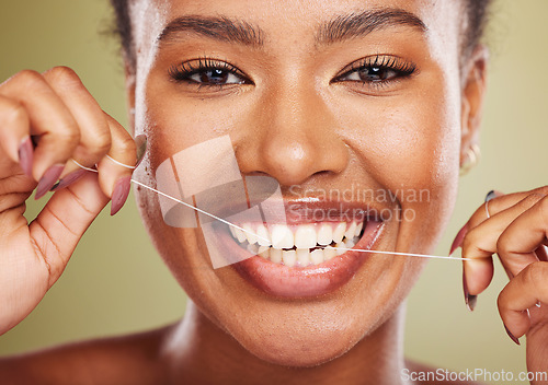 Image of Black woman, teeth and smile for dental floss, skincare or cosmetic treatment against a studio background. Portrait of happy African American toothy female model flossing mouth for clean oral hygiene
