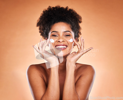 Image of Sunscreen, black woman with skincare product on face and beauty in studio with orange background in Atlanta. Healthy smile for portrait, collagen cream for facial glow or cosmetic lotion for acne