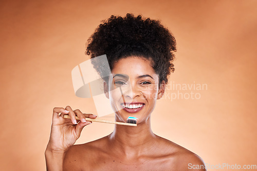 Image of Black woman, portrait and toothbrush for cleaning, teeth and dental health or wellness on a brown studio background. Oral, health and brushing teeth with african american woman with oral hygiene