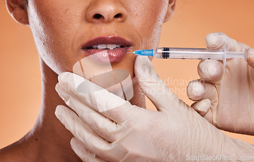 Image of Woman, lips and hands for plastic surgery injection, botox or skincare treatment against a studio background. Hand of medical expert injecting female mouth in cosmetic surgery for fillers or implants