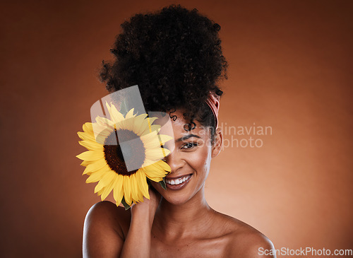 Image of Beauty, skincare and portrait of model with sunflower for health, wellness or body care antioxidants. Facial cosmetics, natural makeup and face of black woman with vitamin e product for diy self care