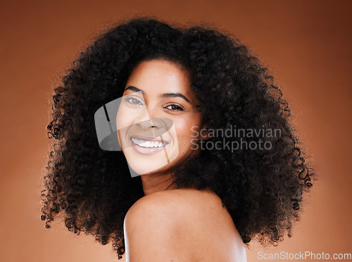Image of Black woman afro, beauty and smile for skincare, makeup or cosmetics against a studio background. Portrait of African American female smiling with teeth in satisfaction for cosmetic facial treatment
