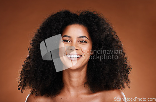 Image of Natural, hair care and black woman in studio portrait for wellness, beauty and luxury with smile happy for shine or glow results. Skin care, healthy hair and young model headshot for salon promotion