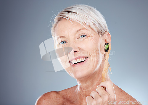 Image of Toothbrush, smile and portrait of a senior woman with a healthy dental routine in a studio. Wellness, cosmetics and happy elderly model with oral care, hygiene and health isolated by gray background.