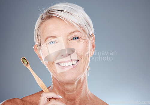 Image of Dental, toothbrush and portrait of senior woman with teeth hygiene, wellness and health in studio. Cosmetic, clean and happy elderly woman with oral care to prevent cavity isolated by gray background