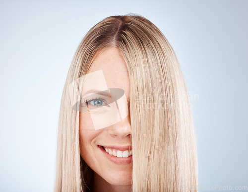 Image of Hair care, smile and portrait of a woman with straight hair against a grey studio background. Wellness, luxury and face of a happy, blonde and beauty model with healthy, clean and beautiful long hair
