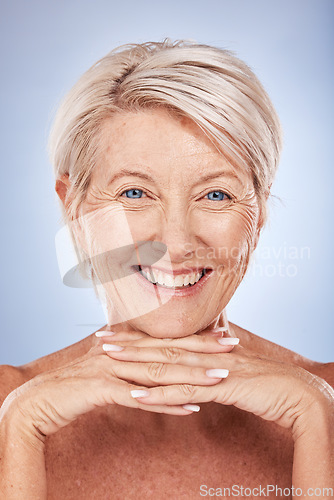 Image of Skincare, wellness and portrait of senior woman with smile on blue background in studio. Beauty, makeup and face of old woman with natural skin pose for dermatology, body care and antiaging cosmetics