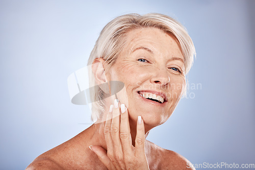Image of Face, beauty and antiaging with a senior woman touching her skin in studio on a gray background for wellness. Portrait, cosmetics and treatment with a mature female posing to promote natural care