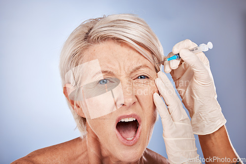 Image of Syringe, face surgery or senior woman in pain getting plastic injection, medical skincare or healthcare facial product. Medicine, aesthetic or skin dermatology beauty spa, wellness model or prp.