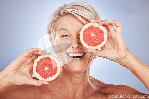 Image of Grapefruit, portrait of happy senior woman in studio or natural skincare product for vegetarian lifestyle. Detox diet for retirement, elderly healthcare nutritionist on gray background or clean face