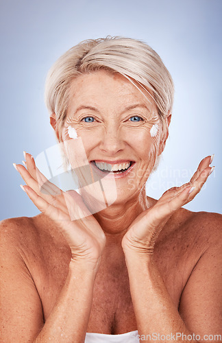 Image of Beauty, portrait of mature woman and cream for skincare, anti aging and wellness on a grey studio background. Skin care, moisturiser or lotion with a senior female apply suncream or spf on her face