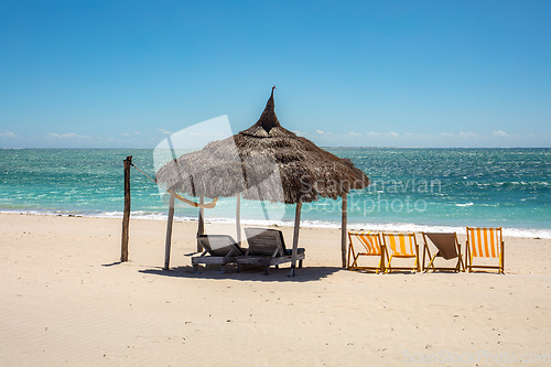 Image of Anakao beach in Madagascar, with a clear blue sky, a comfortable sun lounger