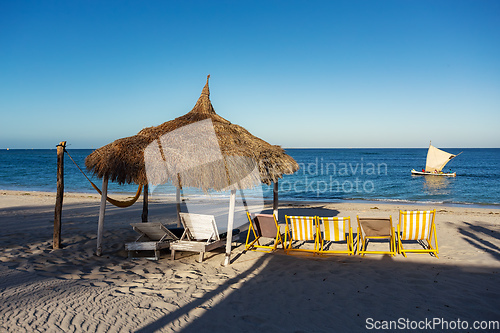 Image of Anakao beach in Madagascar, with a clear blue sky, a comfortable sun lounger