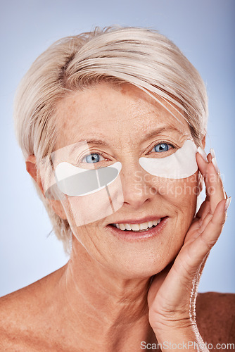 Image of Skincare, beauty and senior woman with patches for eyes, wellness and cosmetics against a grey studio background. Spa, luxury and elderly model with a facial product for body care, wrinkles and aging
