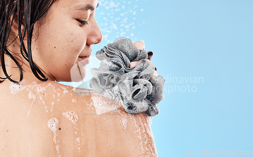 Image of Shower, sponge and woman cleaning body with water, soap foam and skincare for wellness, personal hygiene and cosmetics on mockup studio blue background. Asian girl model, beauty and bath with loofah
