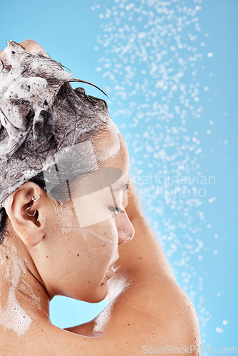Image of Beauty, woman in shower and shampoo hair for haircare health, wellness and cosmetics product on blue background. Healthcare, hygiene and body wash with water of studio advertising or marketing mockup
