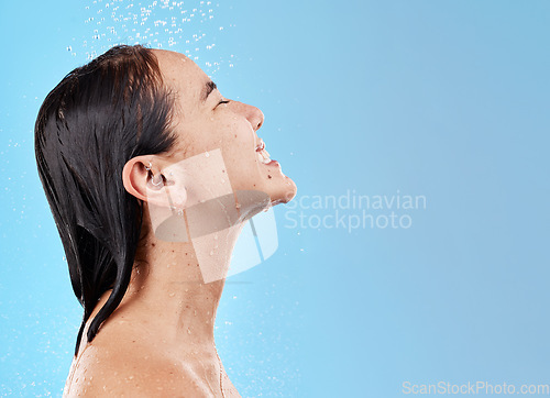 Image of Shower, clean and woman with water for hygiene and grooming with beauty and skincare against blue studio background. Cleaning mockup, wet and hair care with wellness and water drops when washing.