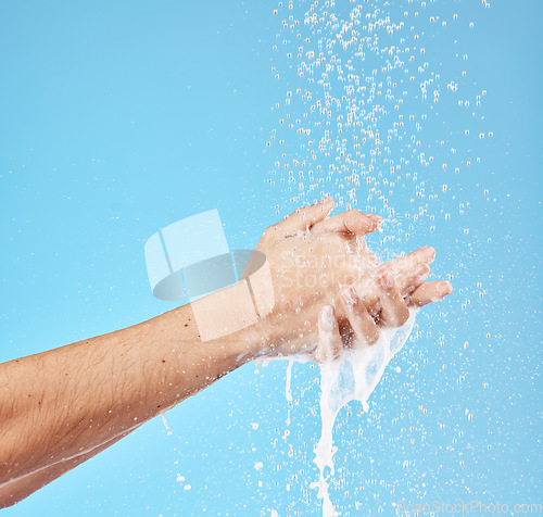 Image of Cleaning hands, water splash and wash for hygiene, healthcare and wellness mockup on a blue studio background. Skin hydration, moisturizing skincare skin and protect from bacteria, germs and disease