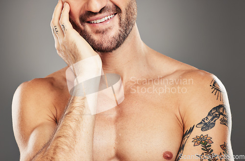 Image of Man, smile and hand on face for happy skincare beauty or skin wellness in studio. Facial healthcare, cosmetics beard care and self care happiness lifestyle for morning routine against grey background