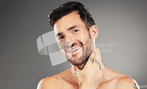 Image of Wellness, skincare and face of man with smile in studio isolated on gray background. Beauty, cosmetics and confident male model posing for skincare products, body care and grooming for healthy skin