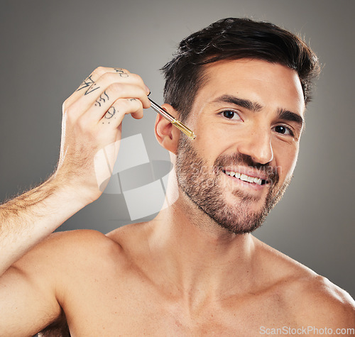 Image of Skincare, health and portrait of man with serum on face for anti aging and glowing skin on studio background. Beauty, facial and male model with liquid oil product in pipette for wrinkles treatment.