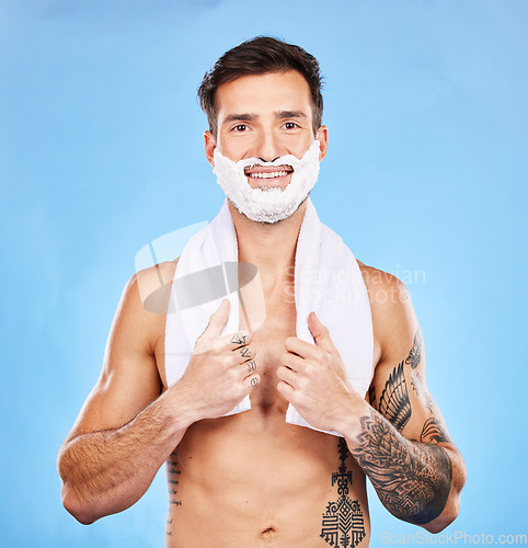 Image of Shave, grooming and hygiene with a man model in studio on a blue background for body or skincare. Portrait, hair removal and beauty with a handsome young male posing to promote hygienic shaving