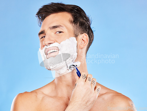 Image of Skincare, shaving and face foam man with facial razor for hair removal, beauty and grooming marketing. Wellness, self care and beard cosmetic model with blue studio advertising mock up.